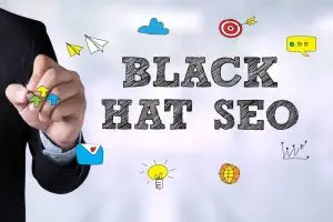 Hand of a man in a suit holding a pen beside sketched words "Black Hat SEO" surrounded by doodled paper planes, a target, lightbulb and chart