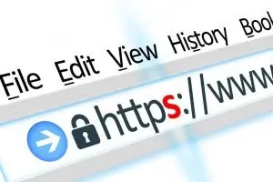 Angled close-up of a browser menu bar and address bar showing a padlock and "https://www" with the letter s highlighted in red