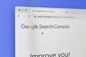 Browser window on a purple background open to search.google.com/search-console/about, showing the Google Search Console logo.