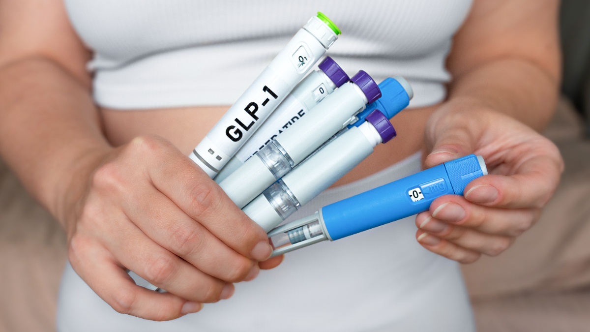 Person holding several GLP-1 weight-loss injection pens